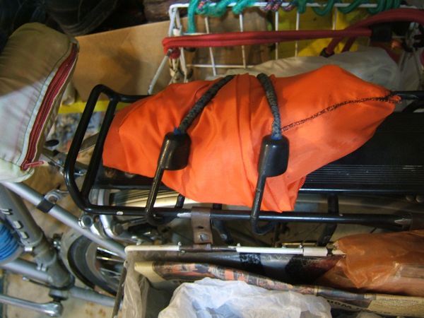 the orange bag bungeed to the rack