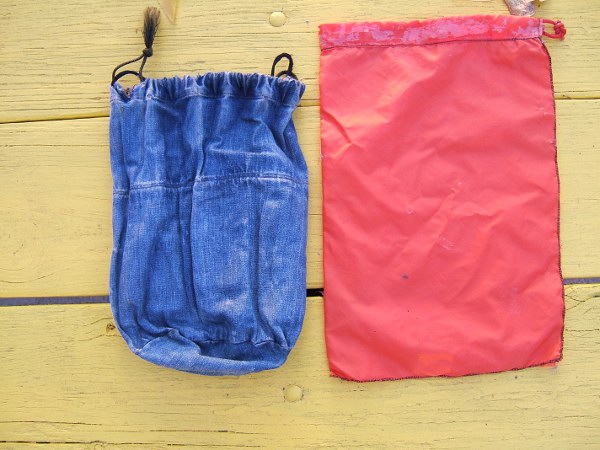 one old purse and an orange drawstring bag