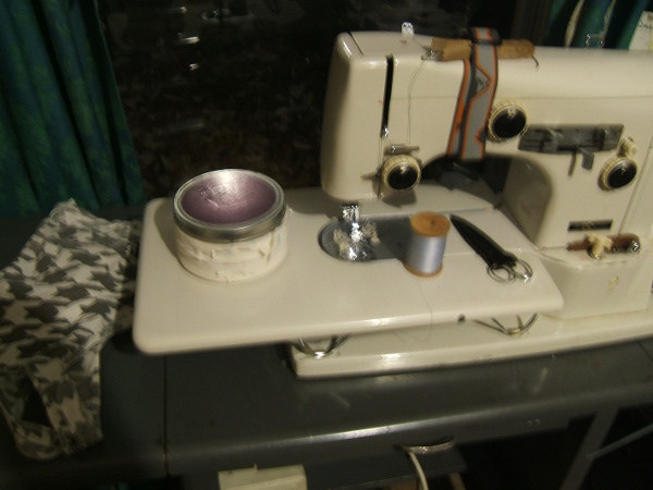 bias-tape tin on sewing machine, with houndstooth bra in view