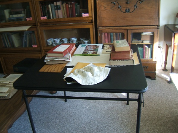 stuff cleared off ironing board on card table