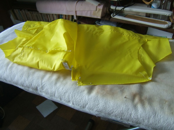 shirt on ironing board, pinning second 
                     shoulder