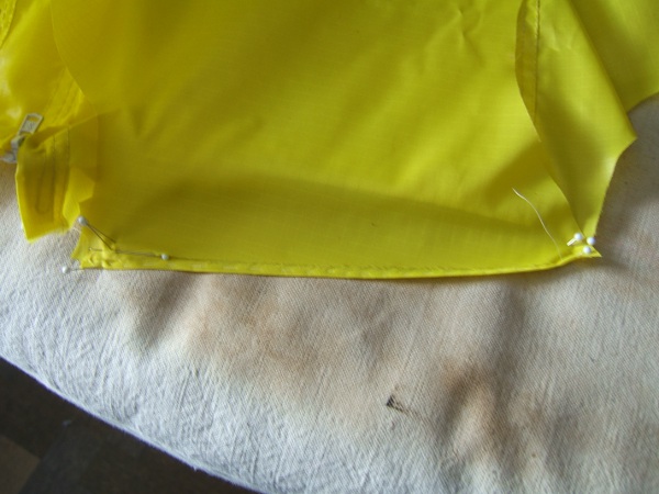 close-up of shoulder 
                     pinned to ironing board