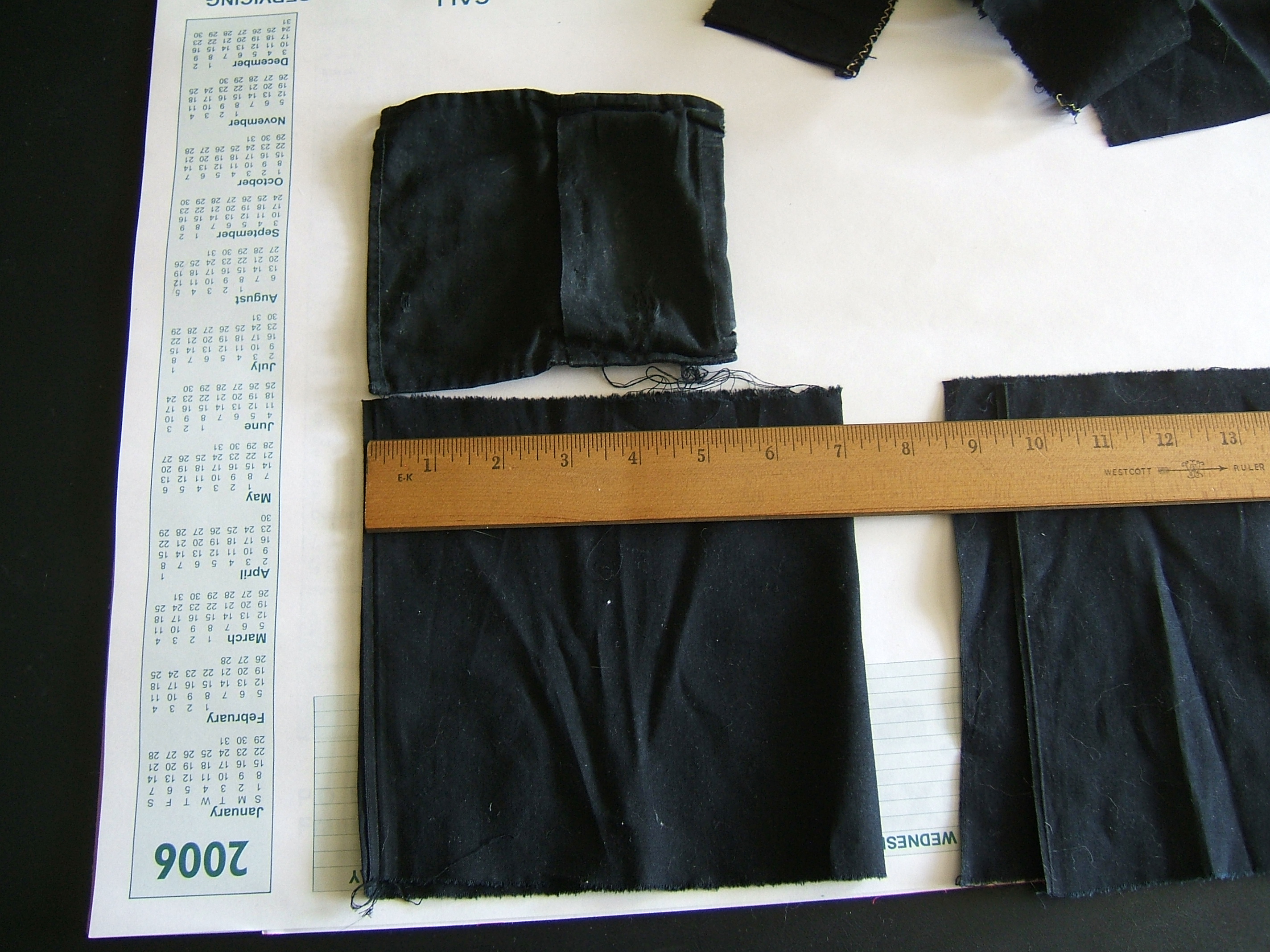 ruler on proposed body, wallet above, pocket scraps to the side