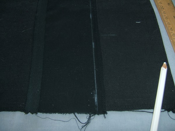 card-pocket strip sewn to main piece, with final-stitching line 
                     marked